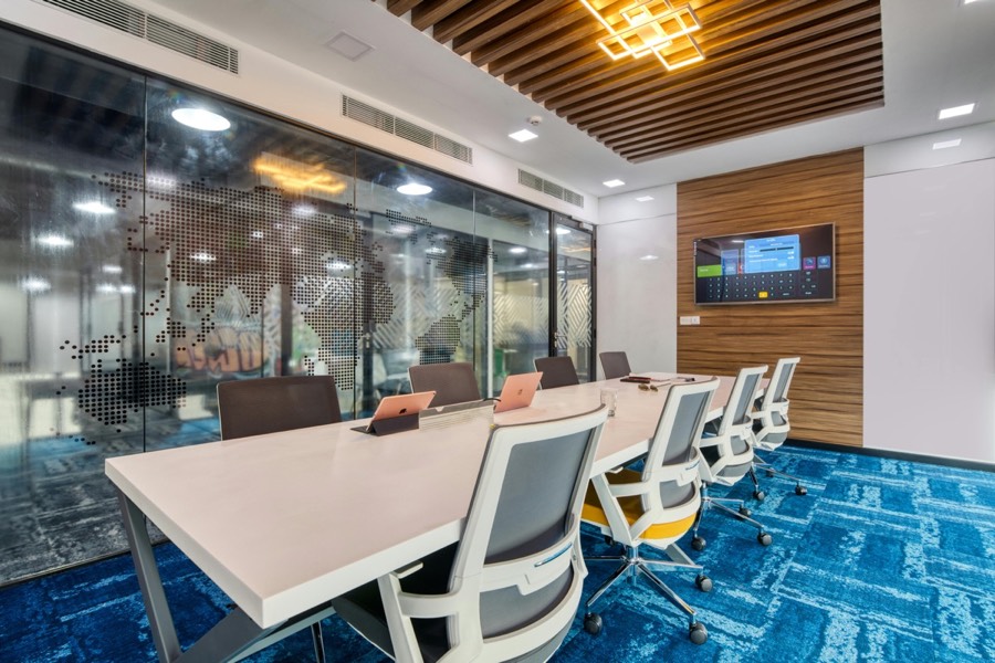 Modern conference room with display screen and conferencing equipment